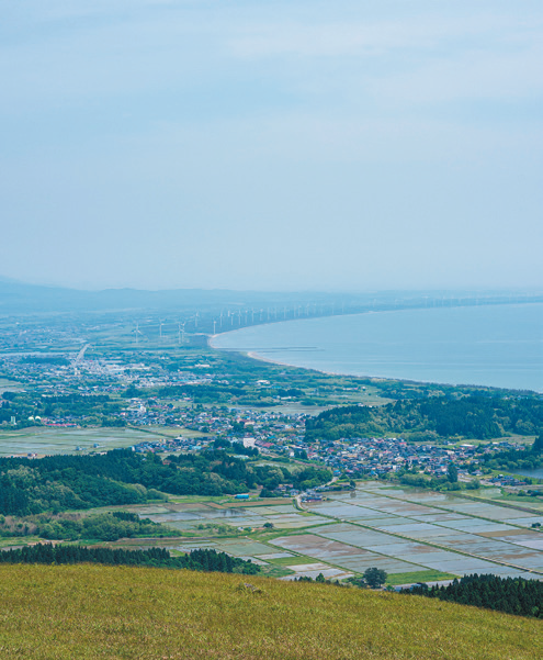 寒風山から撮影した景観写真。右奥側に海岸、左手前側には住居や農地などが見える