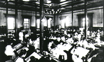 Image: staff members from the Meiji period as they examine banknotes returned from circulation