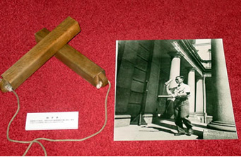 Image: displayed wooden clappers and photo of a staff member using them